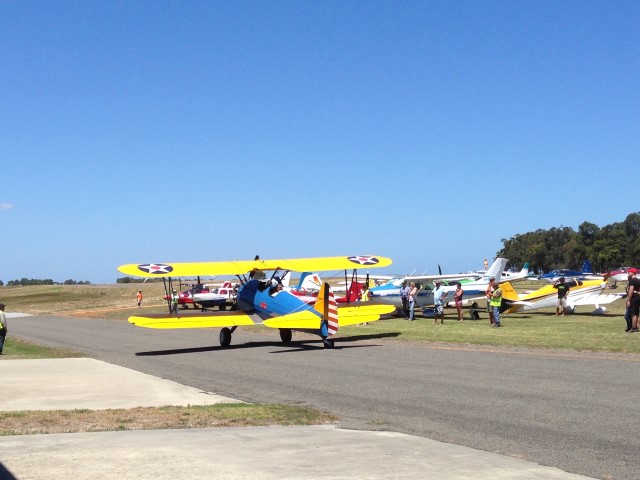 Stearman taxiing out past other aircraft on departure back to Serpentine