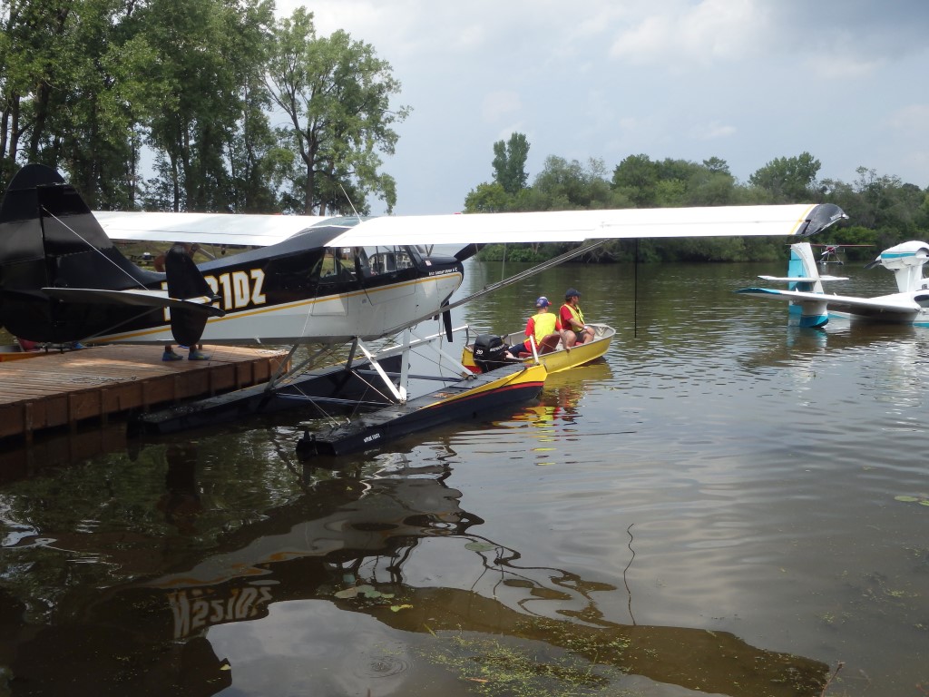 Another aircraft at the lake being towed out to the startup area and then taxiing out onto the lake for departure.